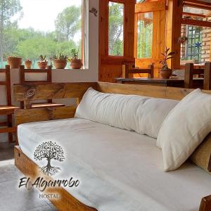 מיטה או מיטות בחדר ב-Hostal El Algarrobo