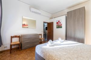 a bedroom with a bed and a dresser and a chair at Firenze Rentals Ponte Vecchio Flat in Florence
