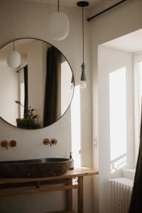 a bathroom with a sink and a mirror at Le Clos Dagobert in Chadeleuf