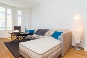 a living room with a couch and a table at Saint François - 1 Chambre - Vue Mer in Nice