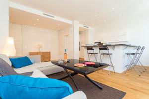 a living room with a couch and a table at Saint François - 1 Chambre - Vue Mer in Nice