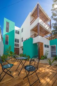 a patio with chairs and a building at Villa Sofía Holiday Accommodation in Cancún