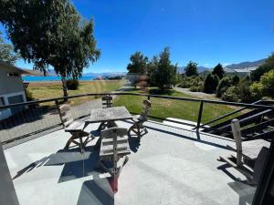 a picnic table on a patio with a view of the ocean at Opera House Beside the Lake in Lake Tekapo