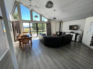 a living room with a large couch and a table at Opera House Beside the Lake in Lake Tekapo