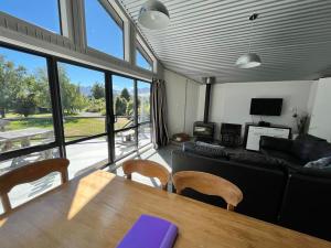 a living room with a table and a couch at Opera House Beside the Lake in Lake Tekapo
