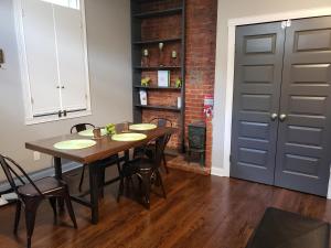 a dining room with a table and chairs and a door at Fresh Modern Industrial split level in Cincinnati