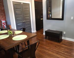 a dining room with a table and chairs and a mirror at Fresh Modern Industrial split level in Cincinnati