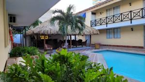 a villa with a swimming pool and a resort at Najhomi Beach in Santa Marta