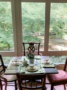a dining room table with chairs and a tableablish at Colonial Gardens B & B in Williamsburg
