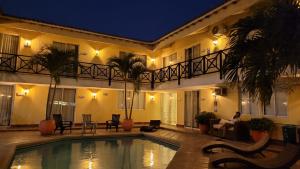 a hotel with a swimming pool in front of a building at Najhomi Beach in Santa Marta