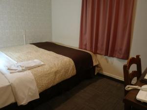 Postel nebo postele na pokoji v ubytování Hamamatsu Station Hotel