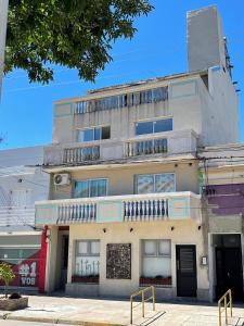 an apartment building with a balcony on top of it at ApartaHotel LaCatedral in Reconquista