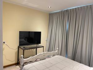 a bedroom with a bed and a computer on a table at ApartaHotel LaCatedral in Reconquista