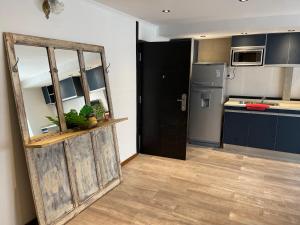 a kitchen with blue cabinets and a black door at ApartaHotel LaCatedral in Reconquista