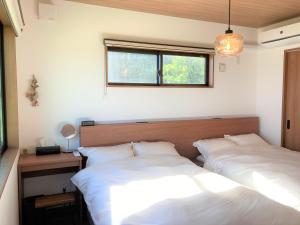 Postel nebo postele na pokoji v ubytování 山里の家