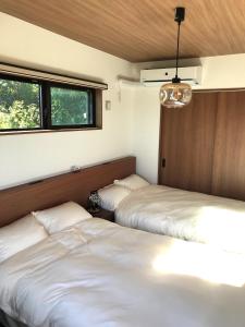 Postel nebo postele na pokoji v ubytování 山里の家