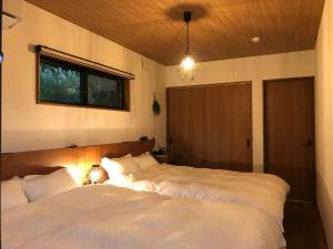 Postel nebo postele na pokoji v ubytování 山里の家