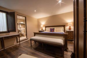 a bedroom with a large bed and a bathroom at Casa Vieja Hotel Boutique in Morelia