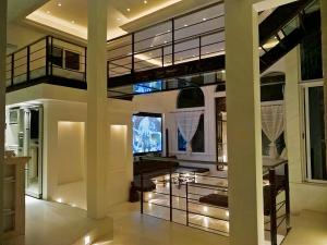 a living room with a tv and a glass ceiling at Mansion Mauresque in Playa del Carmen