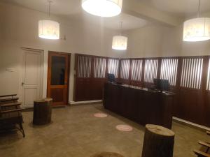 a lobby with a reception desk and two lights at Mango Hill Kodai in Kodaikānāl