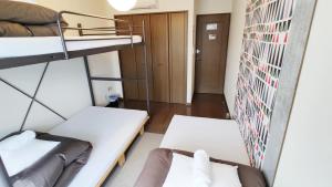 Postel nebo postele na pokoji v ubytování ゲストハウスTSUU小田原 Guest House Tsuu Odawara #OD1