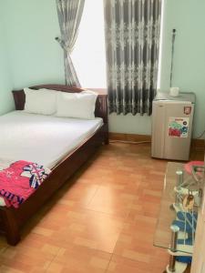 Postel nebo postele na pokoji v ubytování Minh Hiền Hotel + 4 fotografie