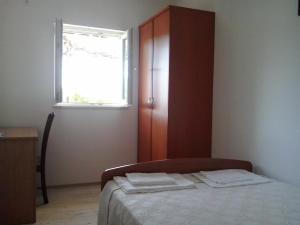 a small bedroom with a bed and a window at Apartment Ljilja in Dubrovnik