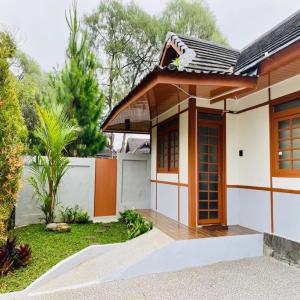 a house with a gate and a fence at SF Homey Yokohama in Cikundul