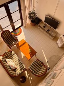 an overhead view of a living room with a table and chairs at Eden Hotel Bangsean in Ban Laem Thaen