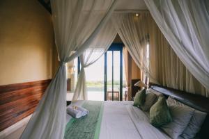 a bedroom with a large bed with a canopy at Puri Arta Villa in Ubud +185 photos