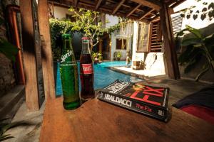 two bottles and a book sitting on a table at Nextdoor Homestay in Yogyakarta