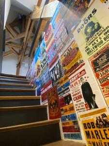 a wall of movie posters on a wall at Loft dans le clocher face au chateau in Bonnelles