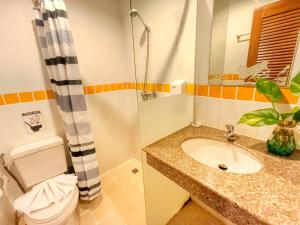a bathroom with a toilet and a sink and a shower at PJ Patong Resortel in Patong Beach