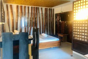 a room with a bed and a desk and a window at E. Moreno Recreation Beach Resort Ilocos Sur in Candon