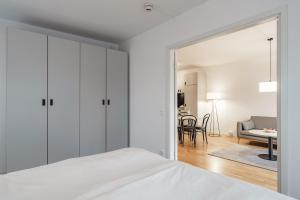 a bedroom with a bed and a living room at Story Living Lidingö in Stockholm