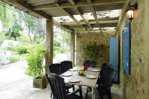 a wooden table and chairs on a patio at Semi-detached house, St Sauveur-le-Vicomte in Saint-Sauveur-le-Vicomte