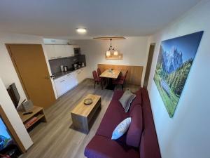 a living room with a couch and a table at Tiroler Alpblick Appartements in Ehrwald