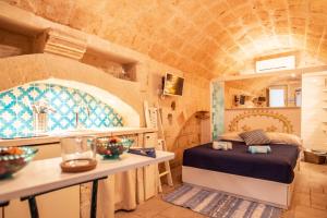 a bedroom with a bed in a brick wall at Casa Monopolina in Monopoli