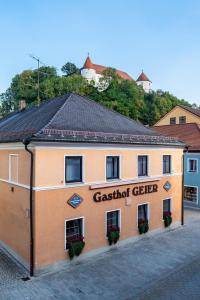 a building with a sign on the side of it at Gasthof Geier in Wörth an der Donau