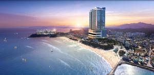 an aerial view of a beach with a tall building at Hotel The Blue Terra in Sokcho