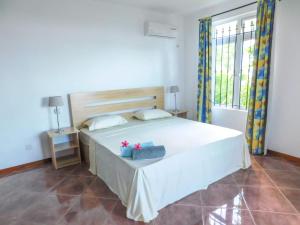 Postel nebo postele na pokoji v ubytování Tulsi Apartment & Studio