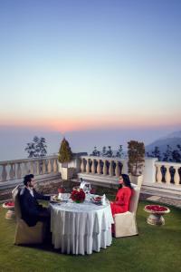 a man and a woman sitting at a table at Jaypee Residency Manor in Mussoorie