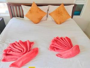a white bed with red mitts on top of it at Tamarind Twin Resort in Ko Lanta +55 photos