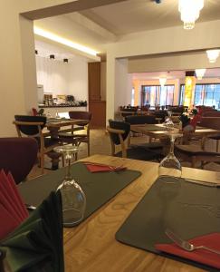 a dining room with wooden tables and chairs at AK LİFE HOTEL&SUIT in Ankara