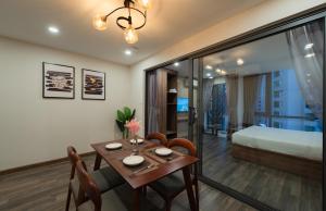 a room with a dining table and a bedroom at The Anchor Apartment - Nha Trang in Nha Trang