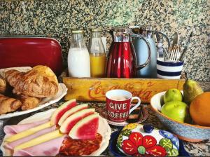 a table topped with plates of food and a cup of coffee at Harveys Homestay - Adults only in Mieras