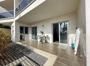 a patio with a table and a building at Cornisa Apartments in Patalavaca