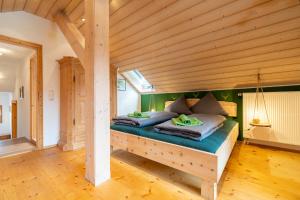 a bed in a room with a wooden ceiling at Ferienwohnung Bergluft in Mittenwald