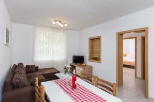a living room with a couch and a table at Villa Celenca in Mokošica