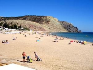 a large group of people on a beach at Luz Beach Center in Luz